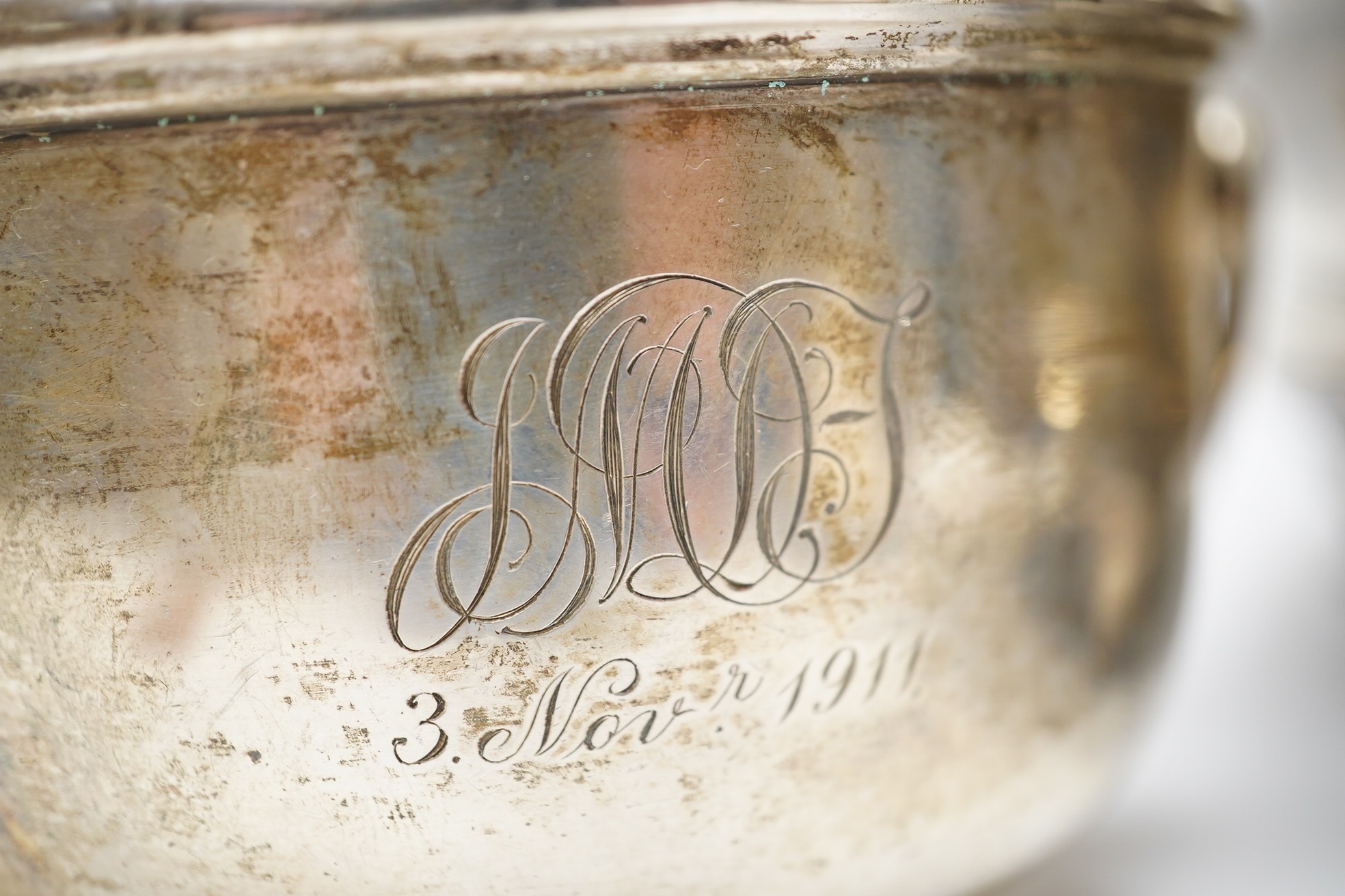 A George III silver oval cruet stand, London, 1804, (lacking bottles), height 28.7cm, together with two silver bowls, one two handled by Mappin & Webb, London, 1911 and a plated bowl and jug. Condition - poor to fair.